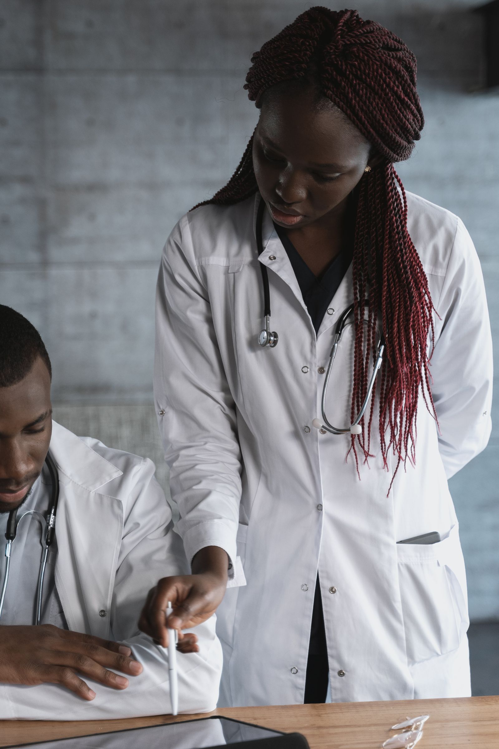 Black doctors reviewing clinical notes together in a healthcare office
