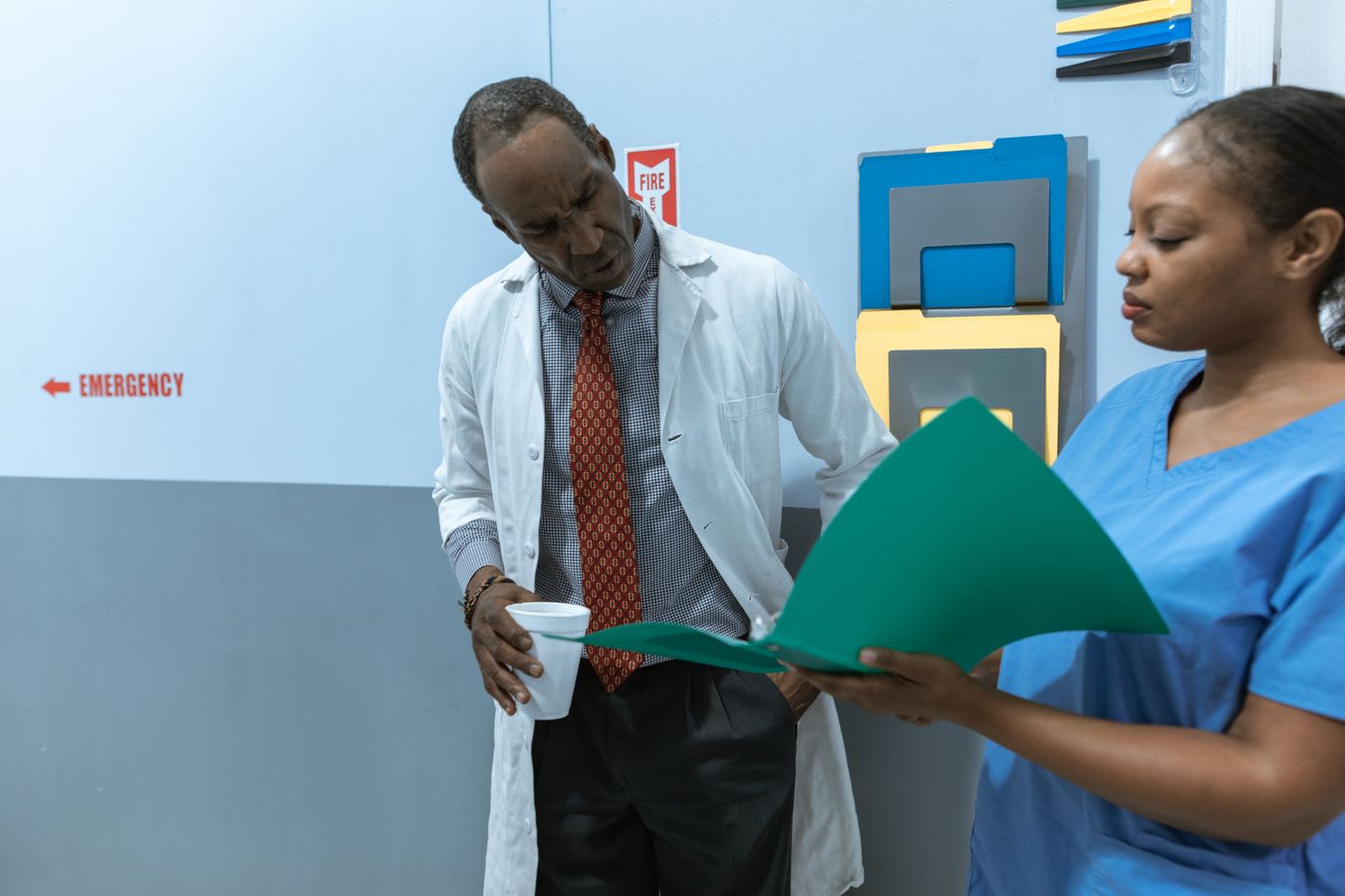 Healthcare provider team coordinating patient approval in a hospital corridor